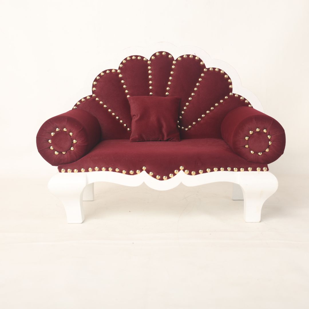 A luxurious royal sofa baby prop with intricate detailing and plush cushioning, designed for newborn and sitter photoshoots, offering an elegant and comfortable setting for capturing regal baby portraits.