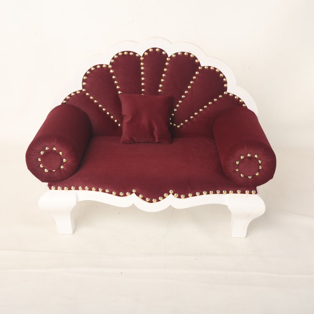 A luxurious royal sofa baby prop with intricate detailing and plush cushioning, designed for newborn and sitter photoshoots, offering an elegant and comfortable setting for capturing regal baby portraits.